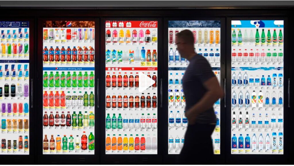 Image of a person walking by doors replaced with digital screens